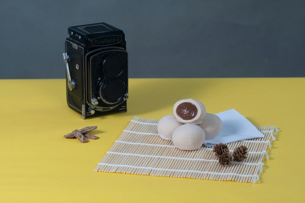 A camera and a cup of coffee on a table