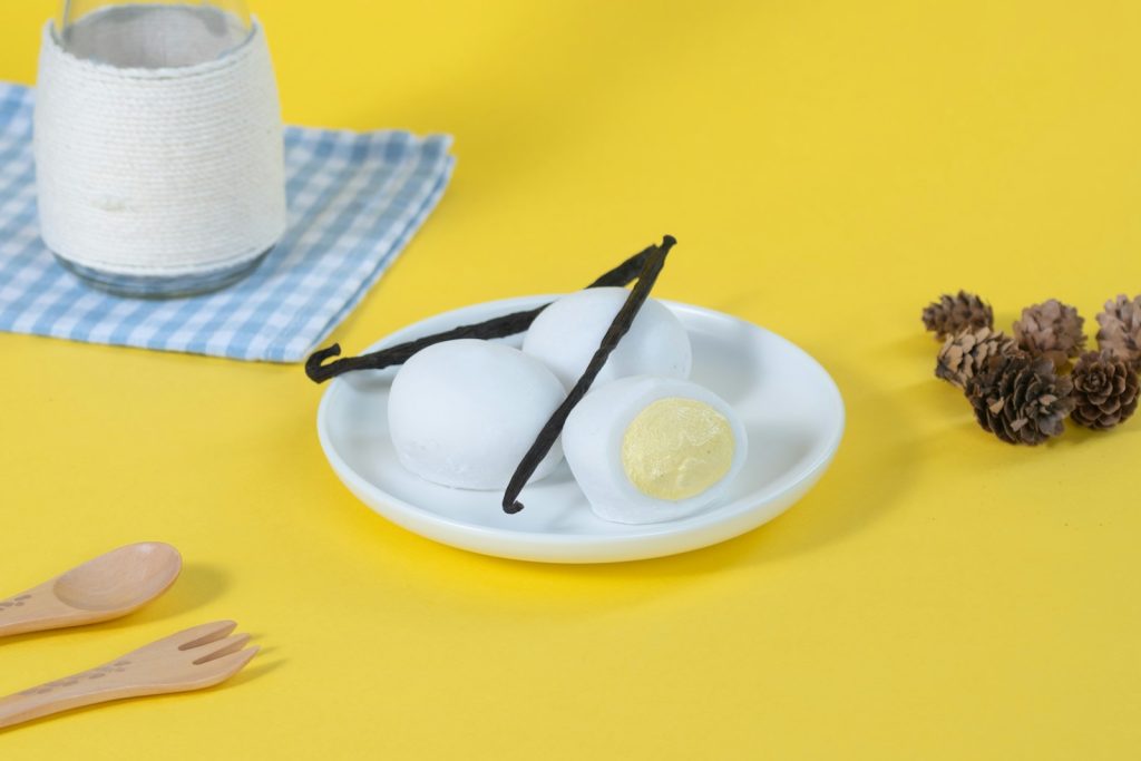 A table topped with a plate of eggs and a glass of milk